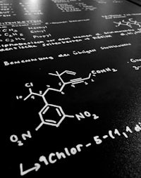a blackboard with chemical formulas written on it